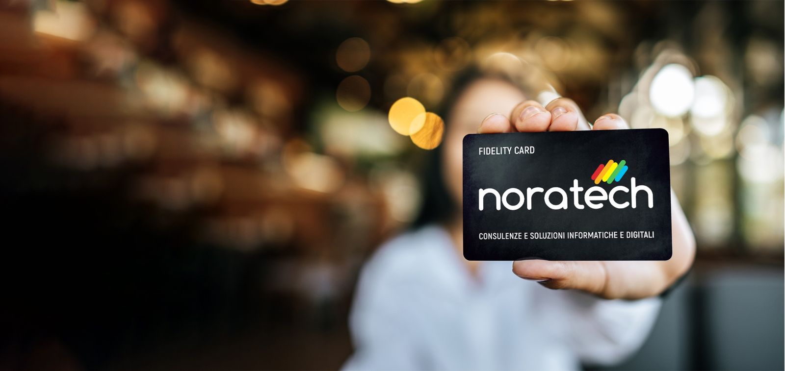 Woman's hand hold noratech fidelity card